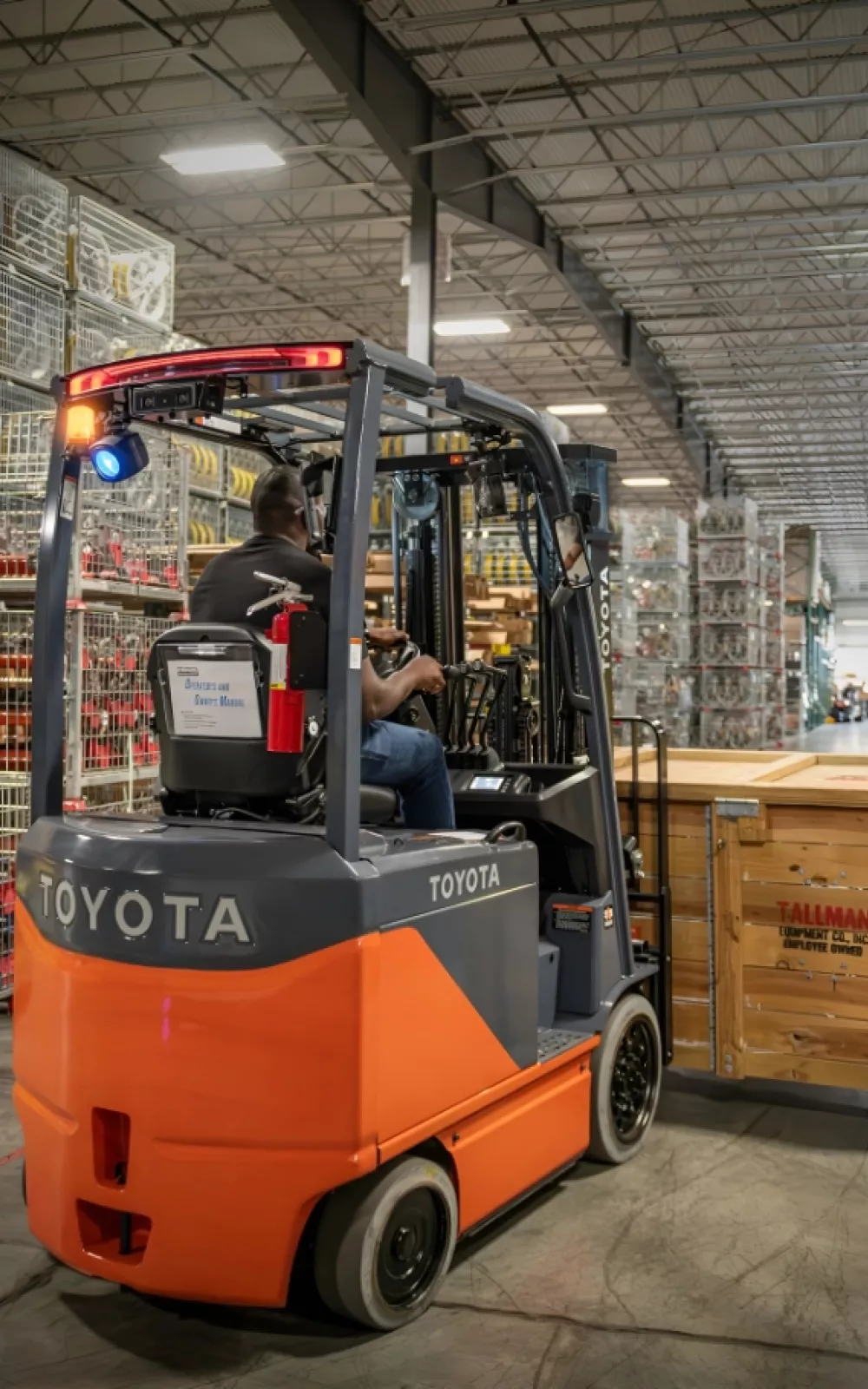 Toyota electric forklift moving boxes on a pallet.