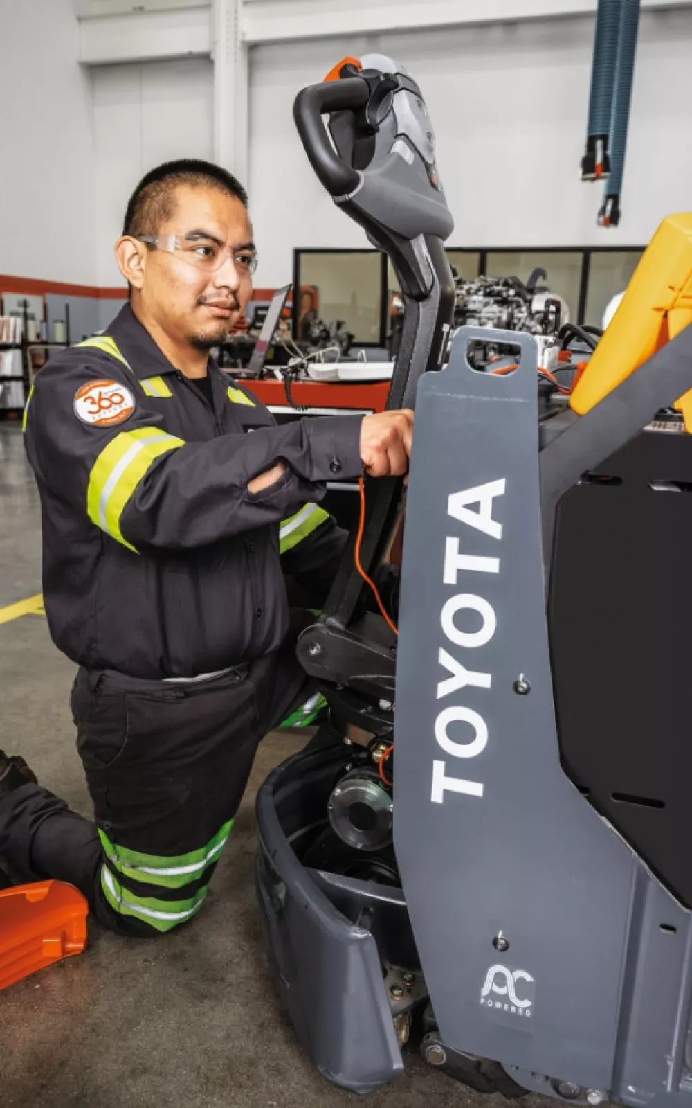 Toyota service technician performing forklift service and repair.