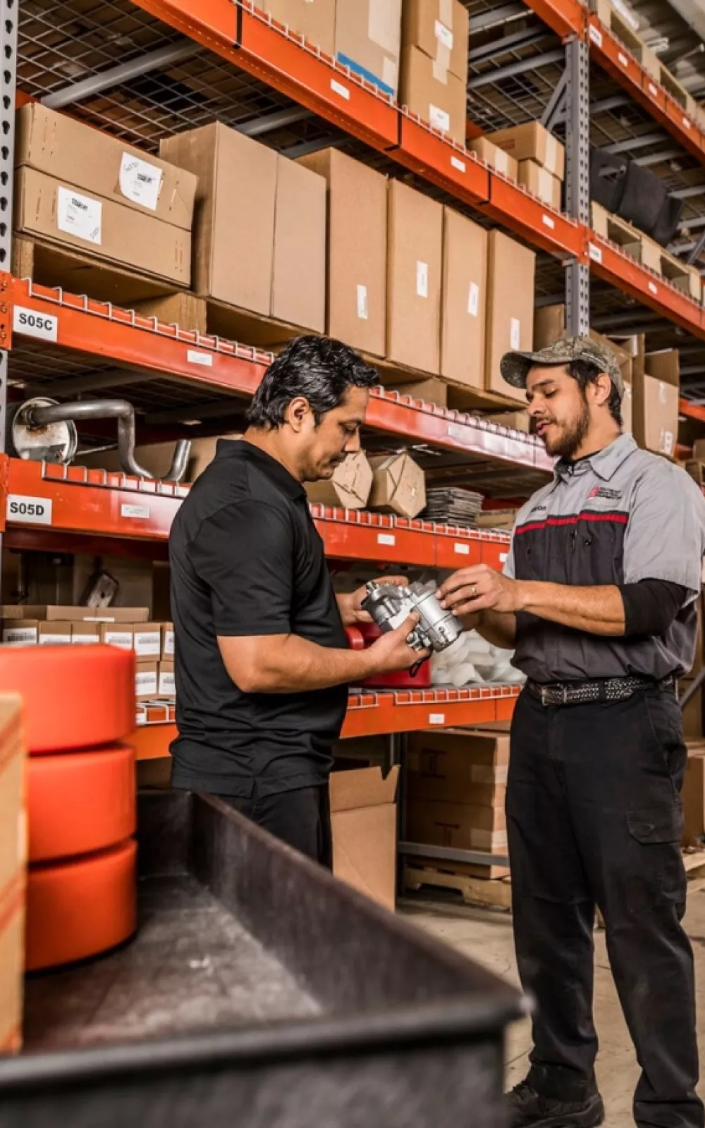 Toyota service technician picking up parts from the dealer's stocked inventory.