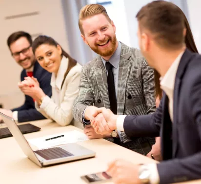 ProLift Toyota corporate support associates shaking hands at a business meeting.