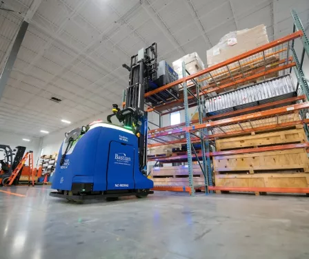 Toyota Bastian Solutions CB18 automated guided vehicle placing product on pallet racking.