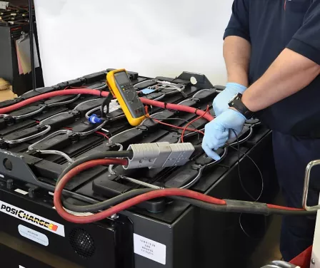 Service technician performing industrial battery service.