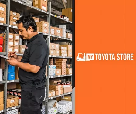 MyToyota forklift parts e-commerce site with parts associate next to shelving.