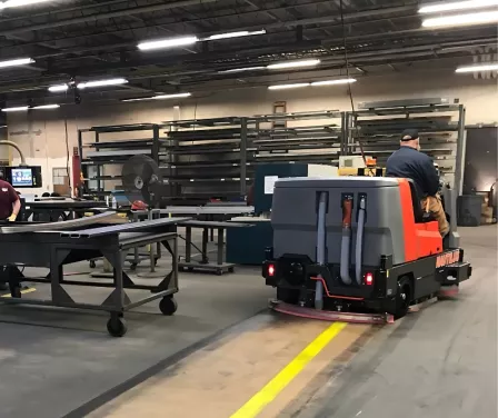 PowerBoss Nautilus industrial floor cleaning scrubber cleaning the warehouse floor.
