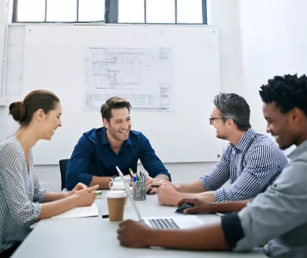 Team members brainstorming at a conference room table.