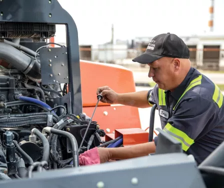 Toyota service technician doing forklift maintenance on a large capacity Toyota forklift.