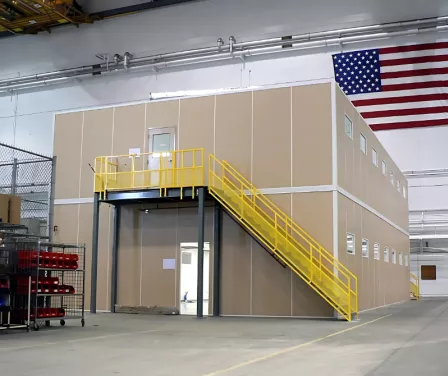 Two-level modular office inside a warehouse.