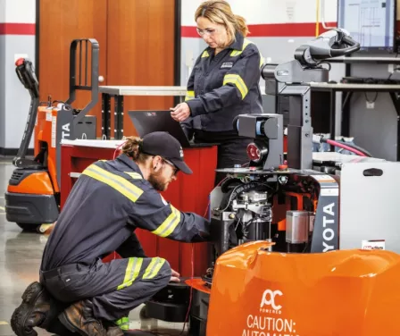 Toyota service technicians performing service on automated guided vehile and AGV parts.