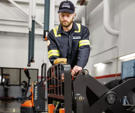 Toyota service technician performing forklift service and repair.