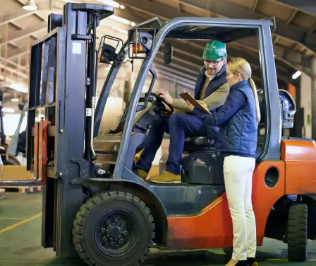 Forklift operator receiving safety training on a Toyota forklift.