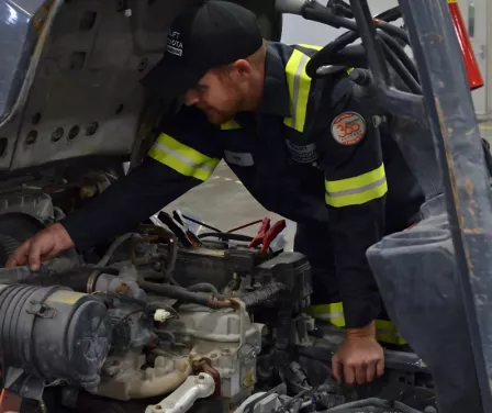 ProLift Toyota service technician evaluating a used forklift for repair.