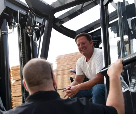 Customer speaking to a ProLift Toyota sales consultant during a forklift equipment delivery.