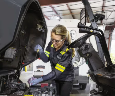 ProLift Toyota service technician repairing a forklift oil leak.