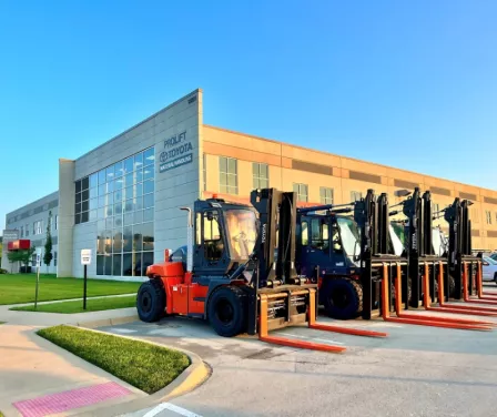ProLift Toyota Material Handling corporate office with large capacity forklifts parked outside.