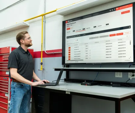 Manager reviewing MyInsights Telematics fleet management reports.