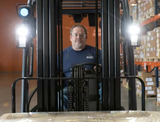Forklift operator receiving safety training on a Toyota forklift.