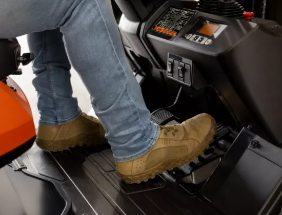 Forklift operator on a Toyota forklift putting their foot on the brake.
