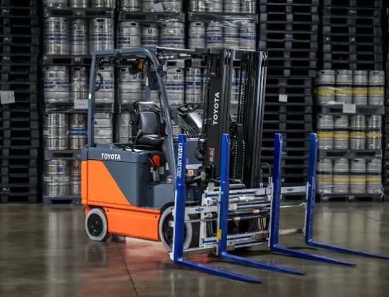 Toyota electric forklift with multiple load handler attachment.