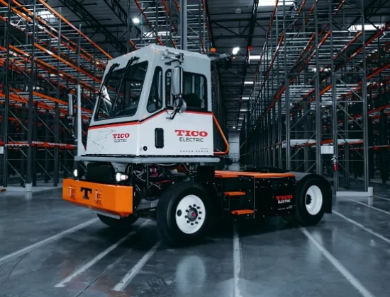 TICO Electric Pro-Spotter terminal tractor sitting indoors near pallet racking.