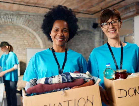 Female associates at community service event with ELEVATE - Women's Impact Network.