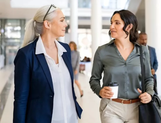 Two women networking at ELEVATE - Women's Impact Group.