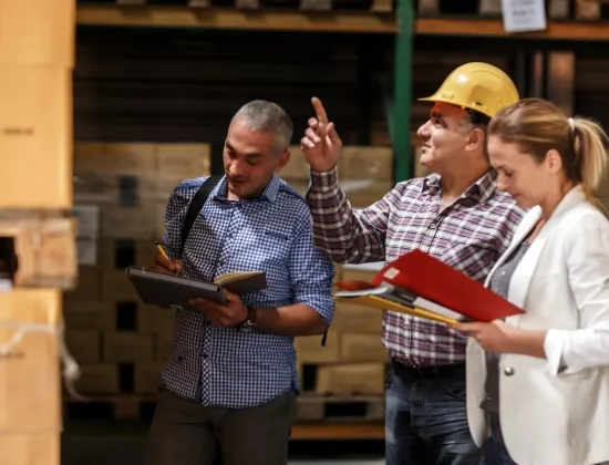 ProLift Toyota material handling sales consultants discussing forklift needs with customer at their warehouse.