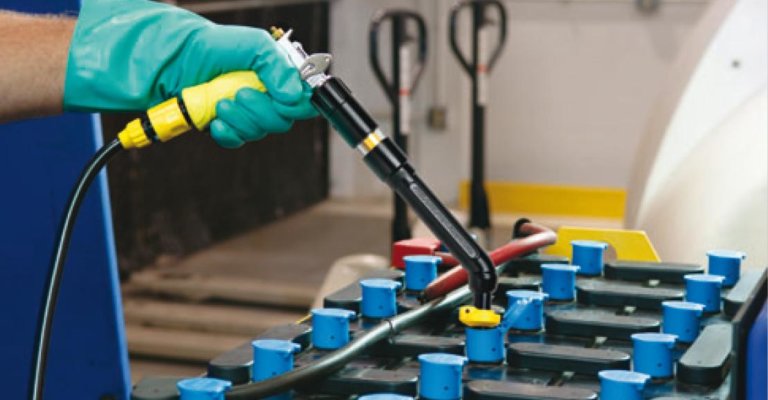 a ProLift Toyota employee wearing green rubber gloves providing Forklift battery maintenance
