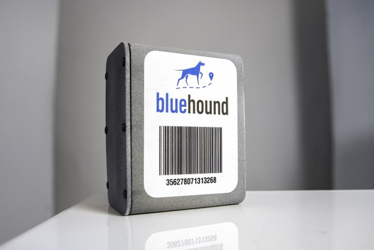 rectangular grey IoT asset tracker with Blue Hound logo and barcode